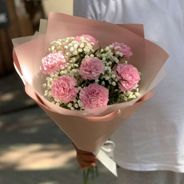 Pink carnation bouquet wrapped in blush paper