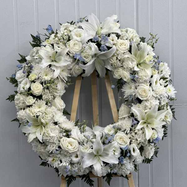 White floral wreath on a wooden easel