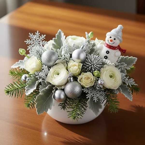 White floral arrangement with a small snowman ornament in a white bowl