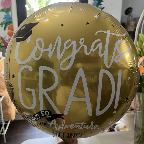 Gold graduation balloon with "Congrats Grad!" text