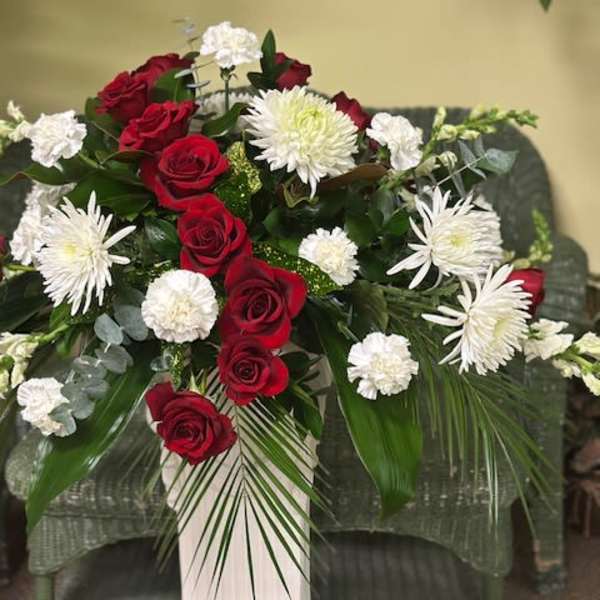 Red roses and white chrysanthemums arranged in a large spray