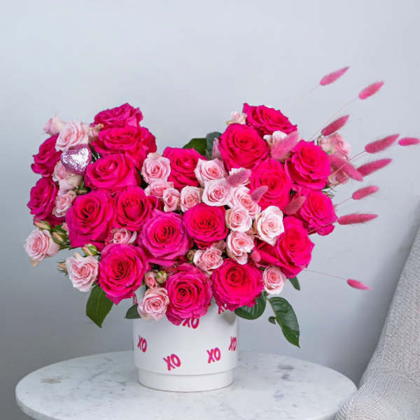 Pink and blush roses in a white box with XO lettering