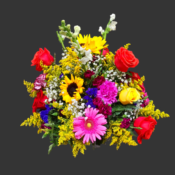 Mixed bouquet with red roses, sunflowers, and a pink gerbera daisy