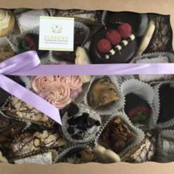 Assorted chocolates in a gift box tied with a lavender ribbon.
