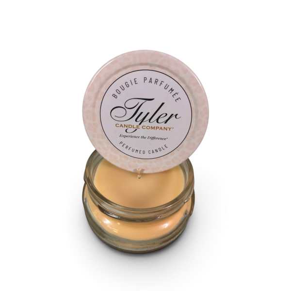Small scented candle in a glass jar with a round lid label