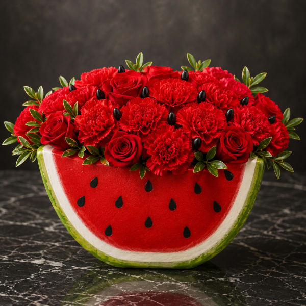 Red roses and carnations arranged in a watermelon-shaped container