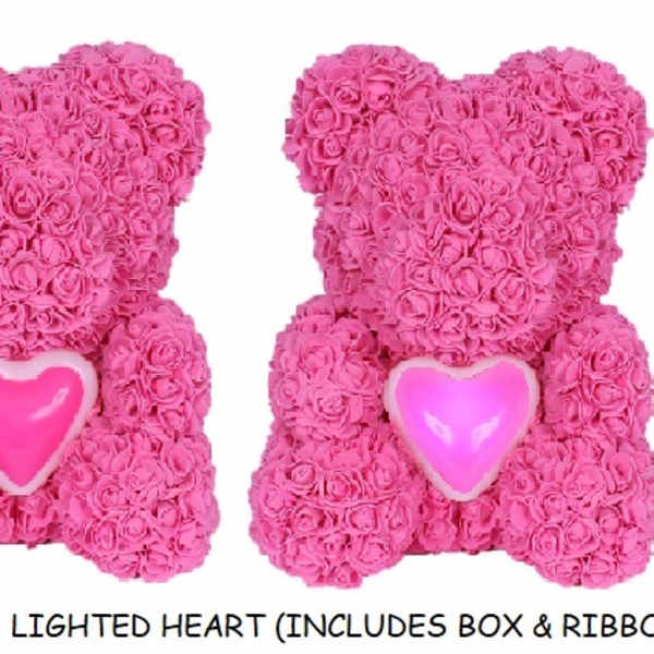 Pink rose teddy bears with heart accents beside a clear gift box