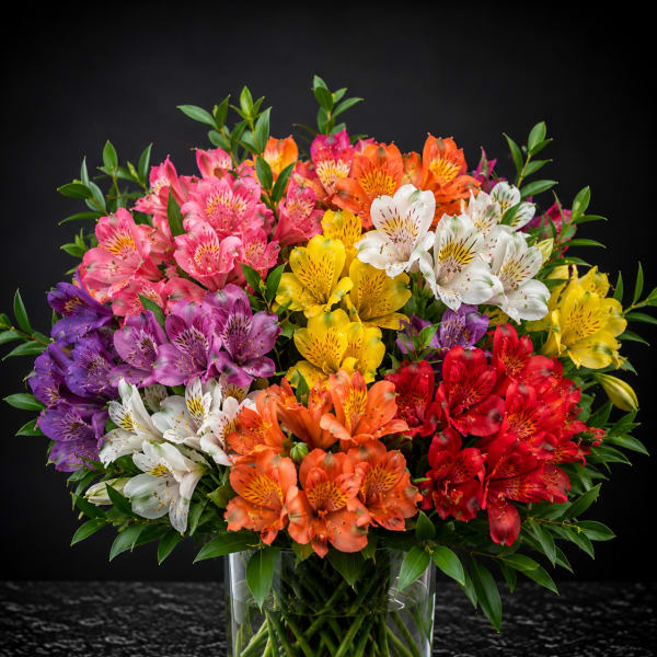 Colorful bouquet of alstroemeria in a clear glass vase