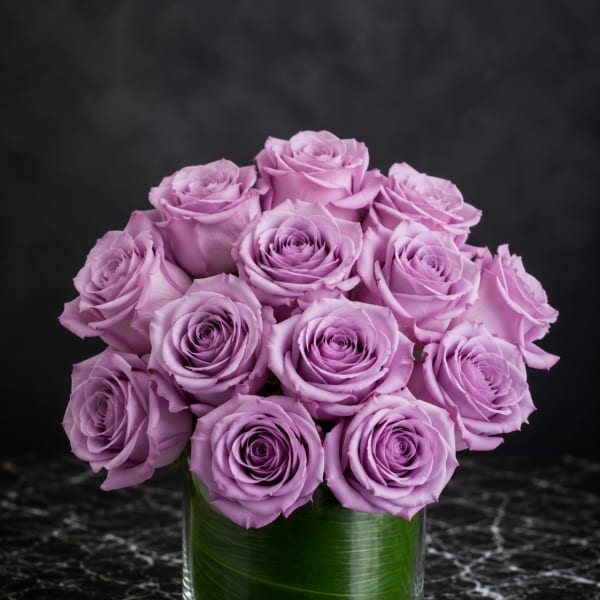 Lavender rose bouquet in a clear glass vase