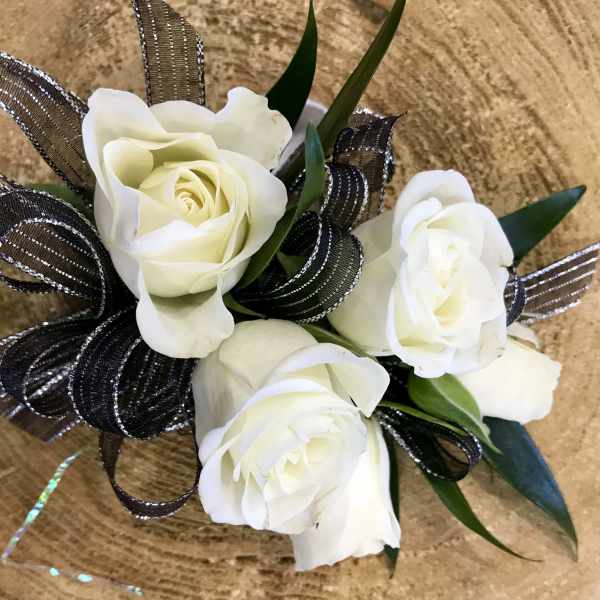 Small bouquet of white roses with black ribbon loops
