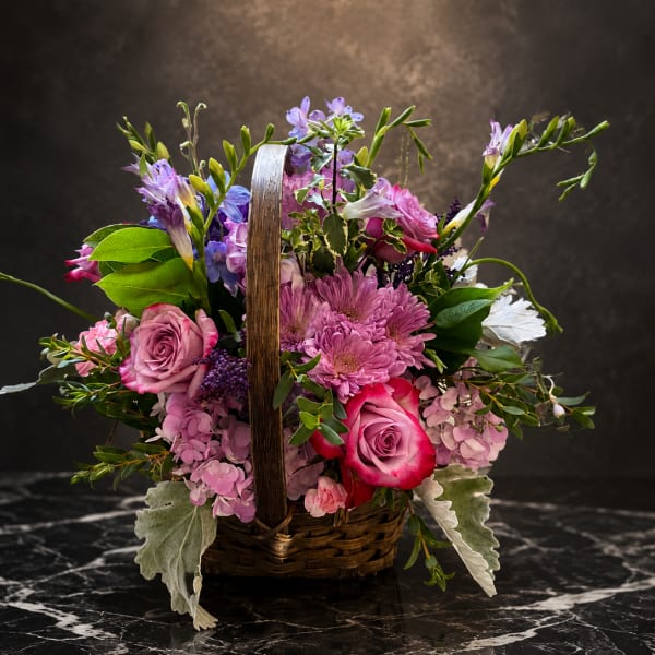 Pink and purple flower basket with roses and chrysanthemums