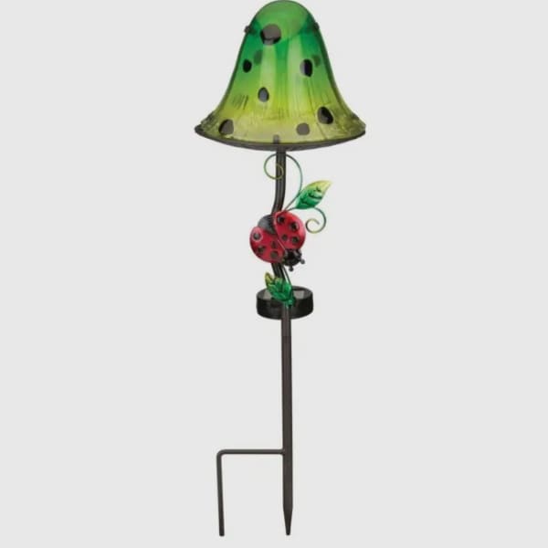 Green garden stake lamp with a ladybug decoration