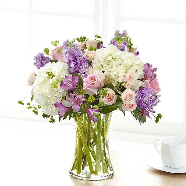 Pink and purple bouquet in a clear glass vase