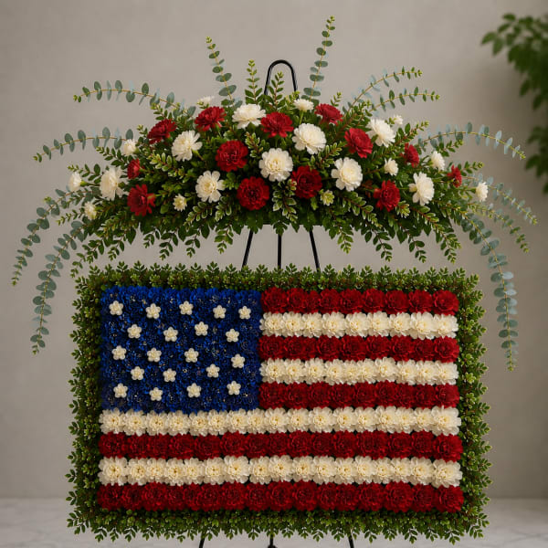 Standing floral tribute shaped like the U.S. flag on an easel