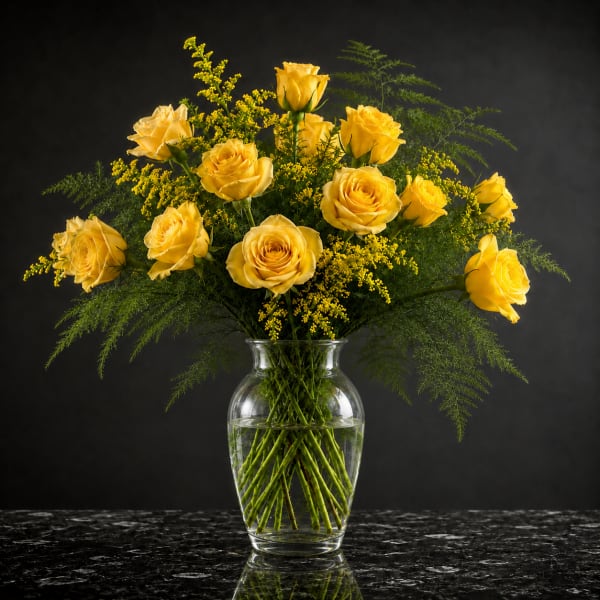 Yellow roses arranged in a clear glass vase