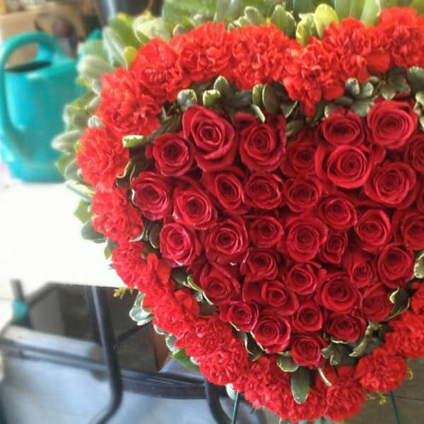Heart-shaped bouquet of red roses and carnations