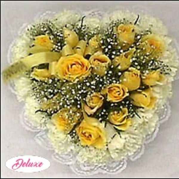 Yellow roses with white baby's breath in a heart-shaped arrangement