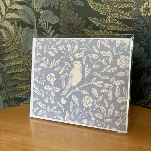 Decorative greeting card with a bird and floral pattern
