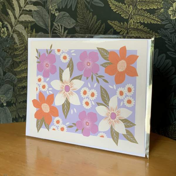 Floral greeting card with pink, orange, and white flowers on a lavender background
