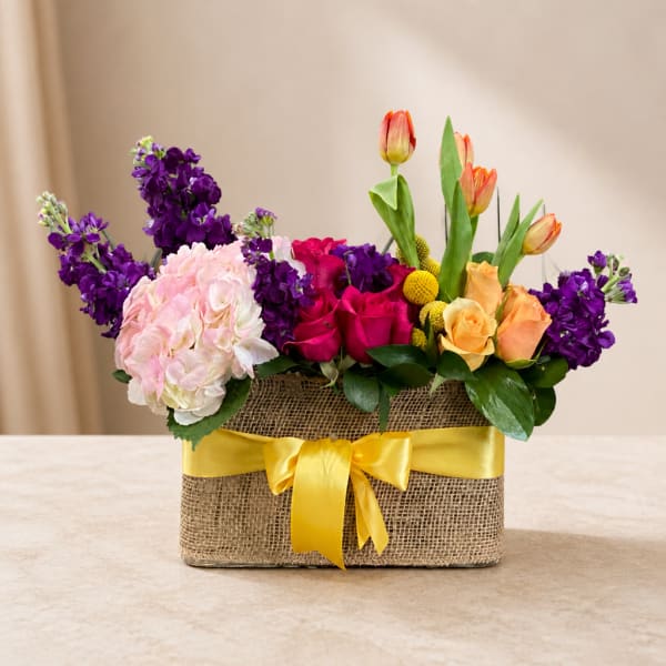 Mixed bouquet in a burlap box with a yellow ribbon