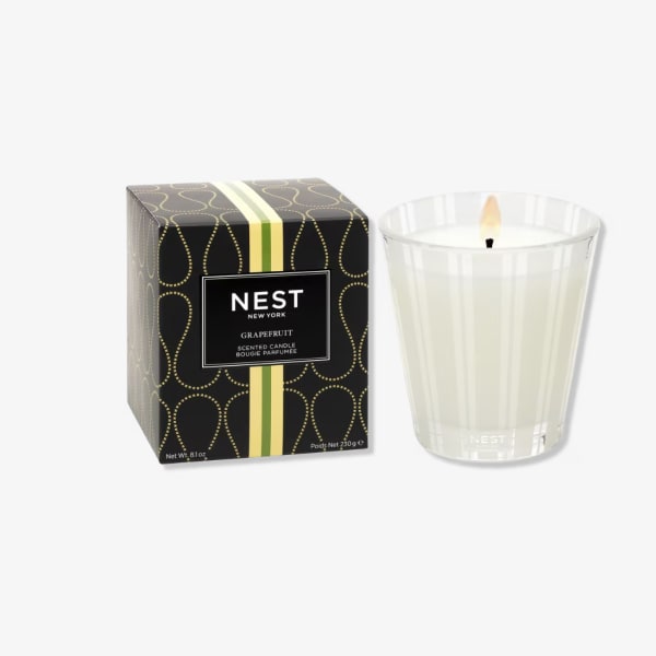 Scented candle in a glass tumbler beside its box