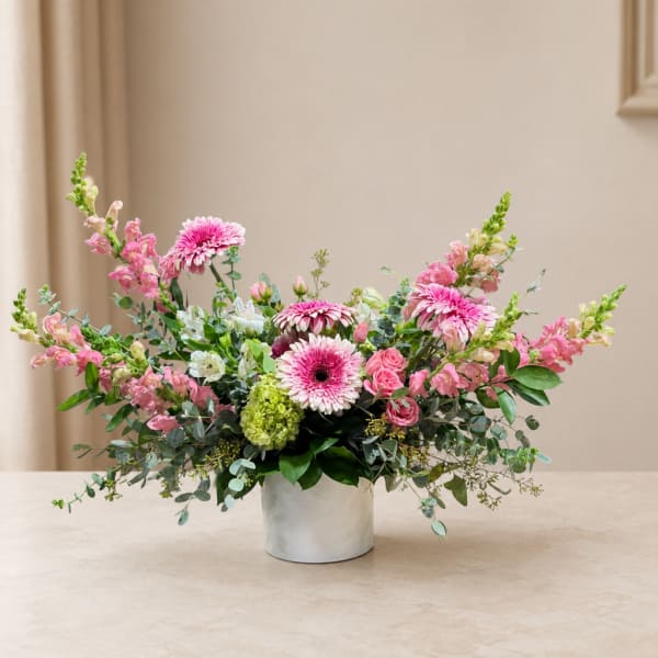 Pink and white mixed flower arrangement in a white vase