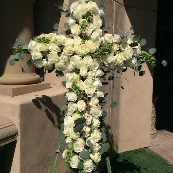 White rose cross arrangement with eucalyptus