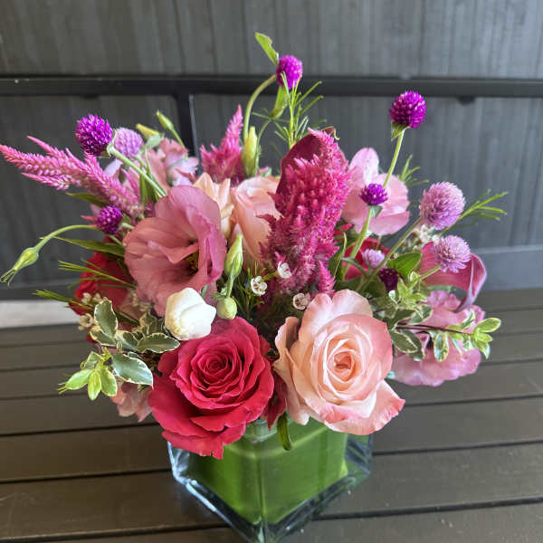 Pink and peach rose bouquet in a clear glass vase