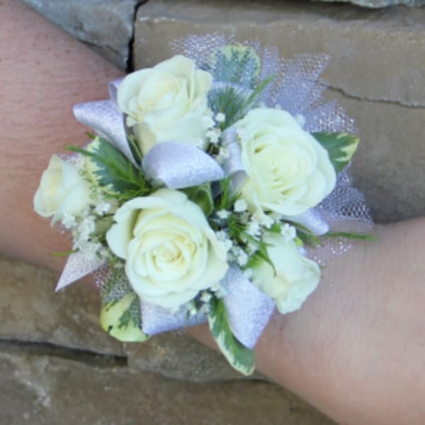 White rose wrist corsage with silver ribbon and small filler flowers