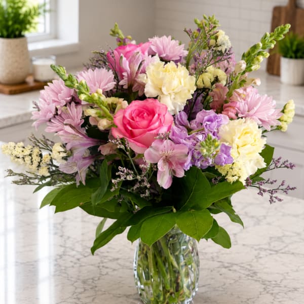 Mixed pink and cream bouquet in a clear glass vase