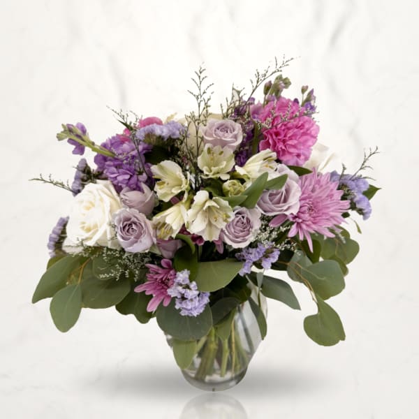 Lavender and pink mixed bouquet in a clear glass vase