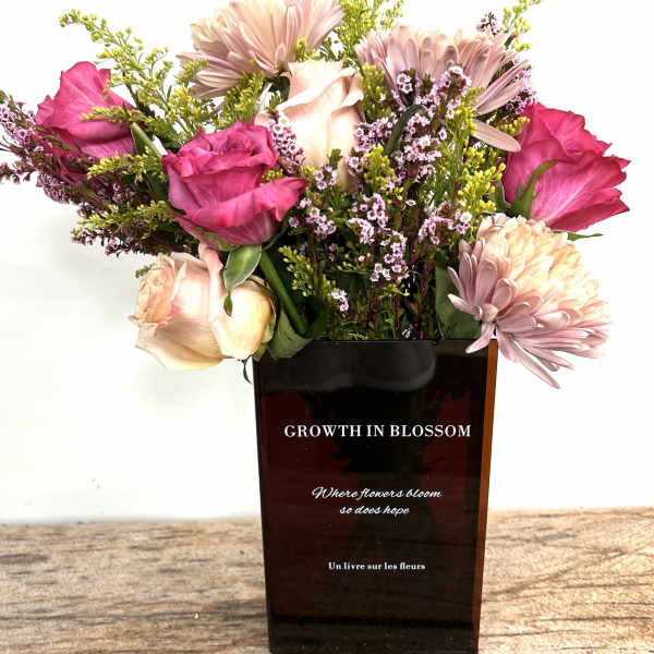 Pink and cream bouquet in a dark rectangular vase