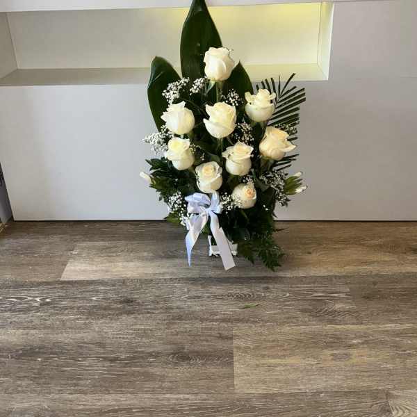 funeral base with white roses