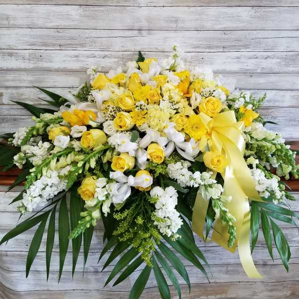 Yellow and white floral spray with a yellow ribbon