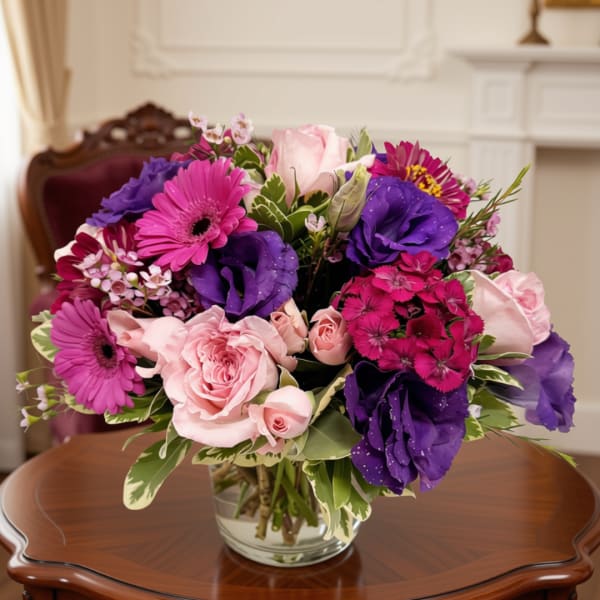 Pink and purple mixed bouquet in a clear glass vase
