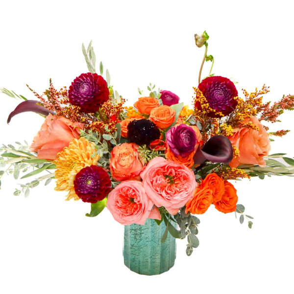 Bright mixed bouquet in a teal vase with roses and orange blooms