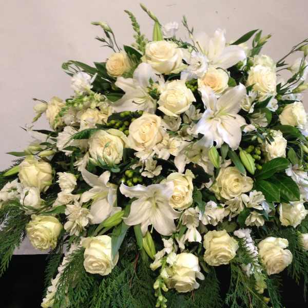 Large white floral spray with roses and lilies