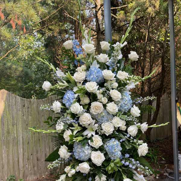 Large standing floral spray with white roses and blue hydrangeas