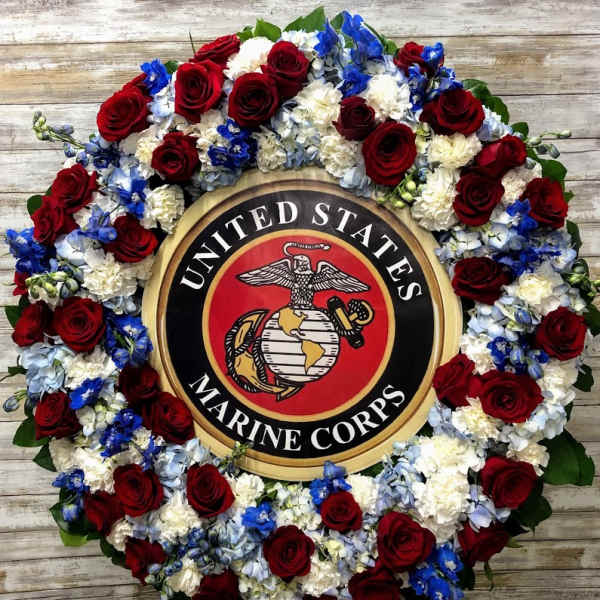 Floral wreath around a United States Marine Corps emblem