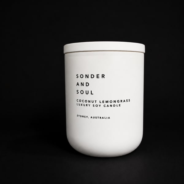 White candle jar labeled Sonder and Soul Coconut Lemongrass