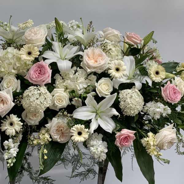Large white and pink floral spray with roses and lilies