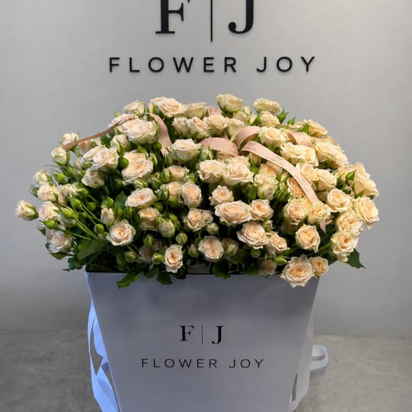 Large bouquet of cream spray roses in a white gift box