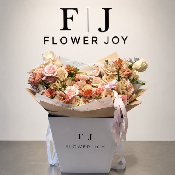 Pink and cream bouquet in a white gift box with ribbon