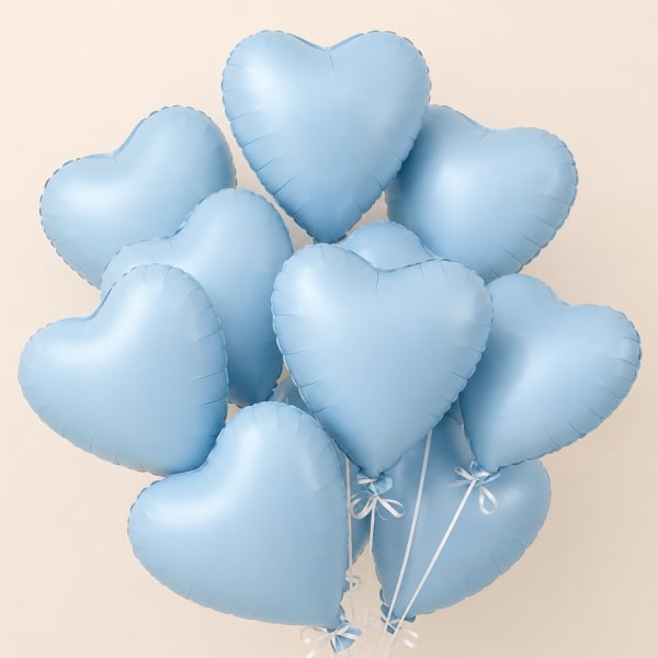Cluster of light blue heart-shaped balloons with white ribbons