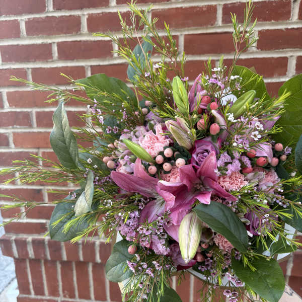 Pink lily and rose bouquet with greenery and small filler flowers