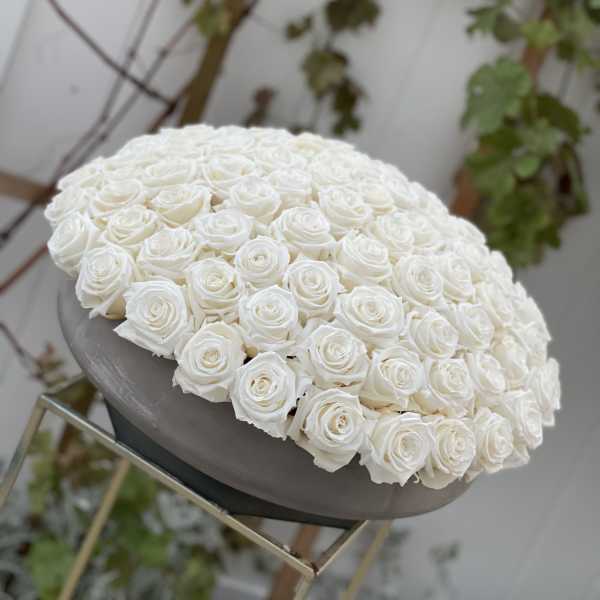 Large dome of white roses on a pedestal stand