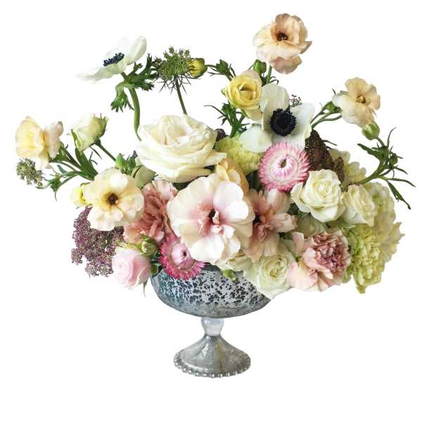 Mixed pastel flower arrangement in a silver pedestal vase