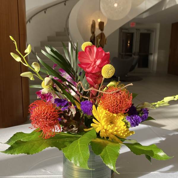Colorful tropical flower arrangement in a glass vase