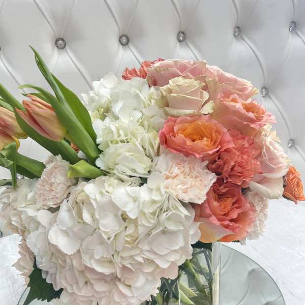 Bouquet of pink and white flowers in a clear glass vase