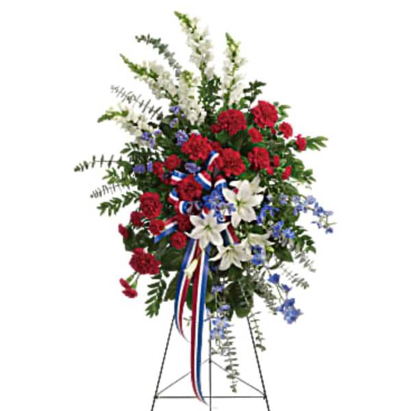 Standing floral spray with red, white, and blue flowers on an easel